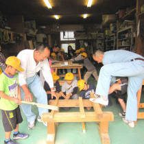 大工さんからのこぎりの使い方を教えてもらう