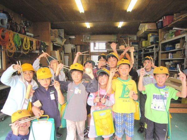 自分でのこぎりとカンナを使って作った箸を片手に集合写真